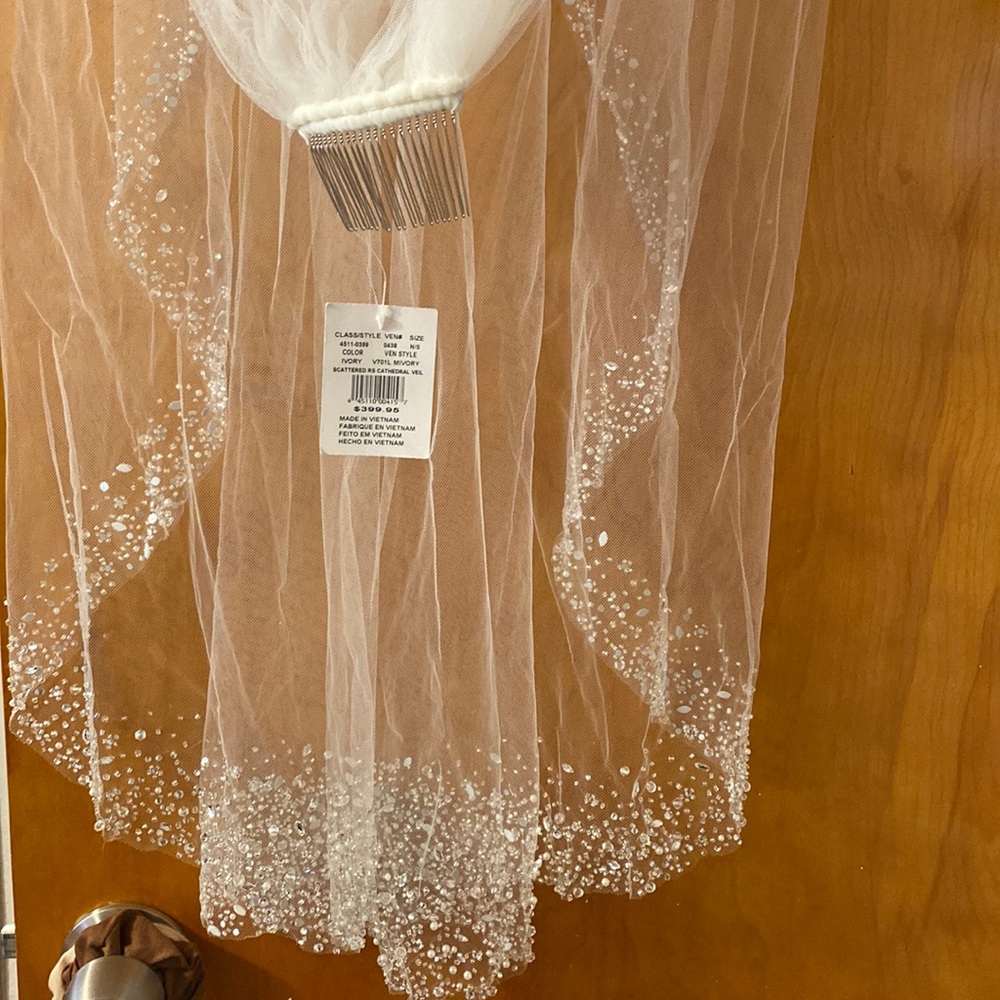David’s bridal ivory cathedral veil with all sequin bottom . Brand new with tags